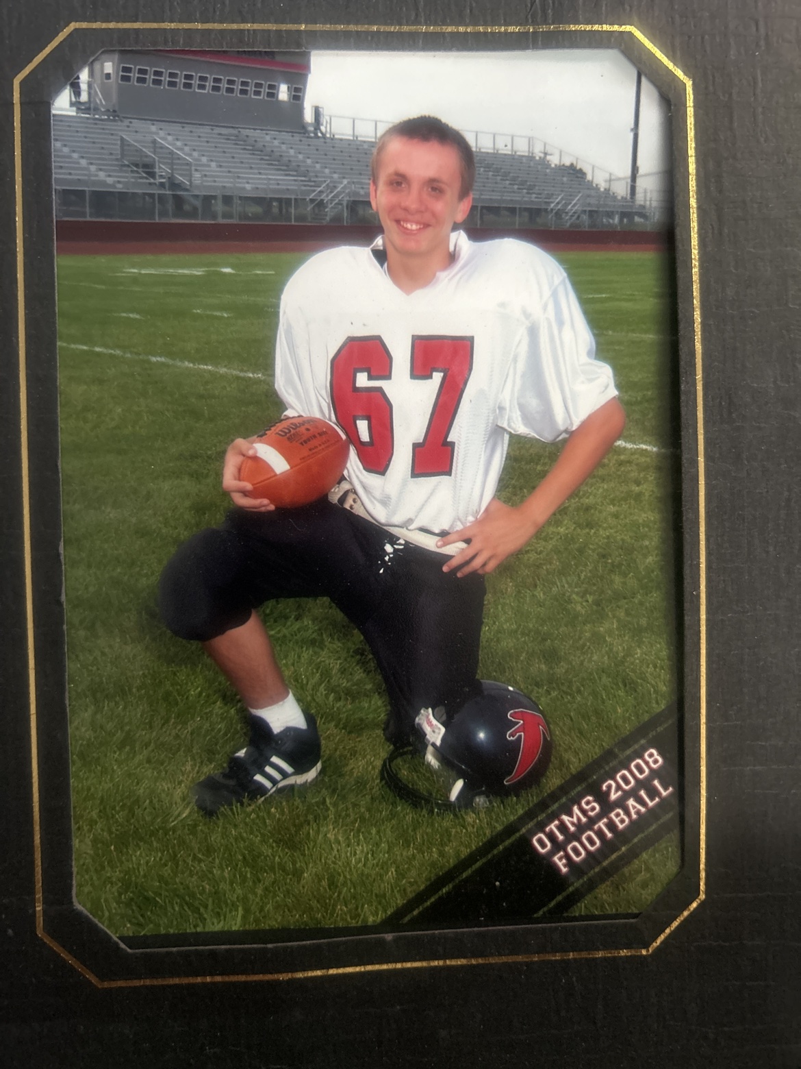 Casey in his football uniform